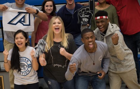 Augusta University students cheer at a basketball game.