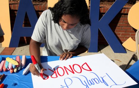 Augusta University student making "Thank You" poster to celebrate "Thank a Donor Day"