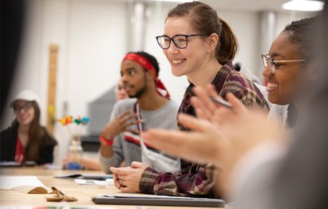 Female student in classroom with other students