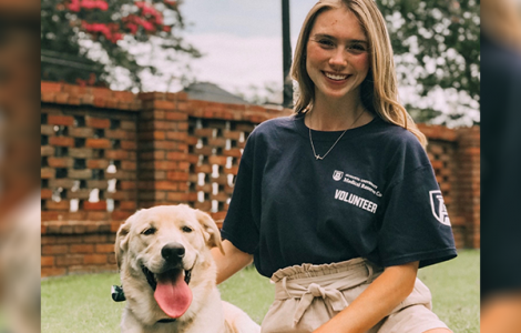 Young woman with dog on grass