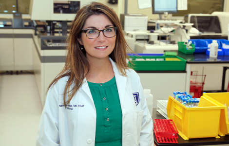 Female physician smiling in science lab